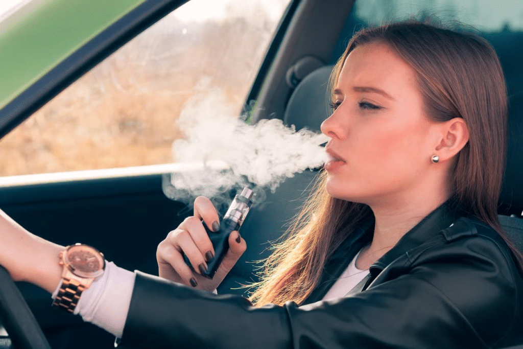 woman vaping while driving
